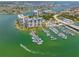 Aerial view of waterfront condo community with many boat docks and access to the bay and Gulf of Mexico for boating enthusiasts at 9495 Blind Pass Rd # 406, St Pete Beach, FL 33706