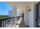 A long outdoor condo balcony showing the parking lot and another condo building nearby at 9495 Blind Pass Rd # 406, St Pete Beach, FL 33706