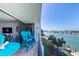 A beautiful balcony features seating and scenic waterfront views at 9495 Blind Pass Rd # 406, St Pete Beach, FL 33706