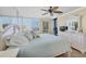 Comfortable bedroom featuring neutral walls, tile floor and a full-wall mirror to enhance the sense of space at 9495 Blind Pass Rd # 406, St Pete Beach, FL 33706