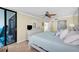Comfortable bedroom featuring neutral walls, tile floor and a glass sliding door for outdoor access at 9495 Blind Pass Rd # 406, St Pete Beach, FL 33706