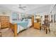 Comfortable bedroom featuring neutral walls, tile floor, and a full-wall mirror to enhance the sense of space at 9495 Blind Pass Rd # 406, St Pete Beach, FL 33706