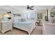 Cozy bedroom features neutral walls, tile floor and a full-wall mirror to enhance the sense of space at 9495 Blind Pass Rd # 406, St Pete Beach, FL 33706