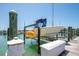 Boat on a lift in the water, next to a dock with a blue sky at 9495 Blind Pass Rd # 406, St Pete Beach, FL 33706