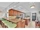 Bright kitchen with granite countertops, center island, stainless appliances, and track lighting at 9495 Blind Pass Rd # 406, St Pete Beach, FL 33706