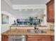 Modern kitchen features granite countertops, stainless steel appliances, and serene water views at 9495 Blind Pass Rd # 406, St Pete Beach, FL 33706