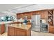 Modern kitchen with granite countertops, stainless steel appliances, and custom wood cabinets at 9495 Blind Pass Rd # 406, St Pete Beach, FL 33706
