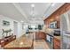 Modern kitchen featuring custom wood cabinets, granite countertops, and stainless steel appliances at 9495 Blind Pass Rd # 406, St Pete Beach, FL 33706