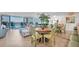 Open-concept living space with dining area, serene water views, and comfortable seating at 9495 Blind Pass Rd # 406, St Pete Beach, FL 33706