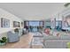 Inviting living room with sliding glass doors to the balcony and comfortable seating at 9495 Blind Pass Rd # 406, St Pete Beach, FL 33706