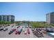 Expansive condo parking lot, tennis court, and condo buildings with water views at 9495 Blind Pass Rd # 406, St Pete Beach, FL 33706