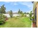 Well-maintained backyard with green lawn, white fence, and landscaping at 11818 Valhalla Woods Dr, Riverview, FL 33579