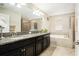 Bright bathroom with double vanity, granite countertop, and separate tub and glass-enclosed shower at 11818 Valhalla Woods Dr, Riverview, FL 33579