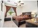 Cozy bedroom with a decorative bed, large window, and elegant curtains, creating a relaxing and inviting space at 11818 Valhalla Woods Dr, Riverview, FL 33579