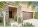 Inviting front entrance with stone accents, a dark wood door, and well-maintained landscaping for a welcoming feel at 11818 Valhalla Woods Dr, Riverview, FL 33579