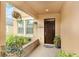 Cozy covered front porch featuring decorative plants and a hanging basket, perfect for enjoying the outdoors at 11818 Valhalla Woods Dr, Riverview, FL 33579