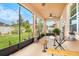 Screened-in lanai offers outdoor seating and a view of the landscaped backyard at 11818 Valhalla Woods Dr, Riverview, FL 33579