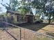 Charming single story home with a fenced front yard and mature landscaping at 12231 Fort King Rd, Dade City, FL 33525