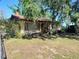 Charming single-story home with a welcoming front porch and mature trees providing shade at 12231 Fort King Rd, Dade City, FL 33525