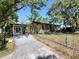 Charming single-story home with a covered carport and fenced yard at 12231 Fort King Rd, Dade City, FL 33525