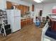 Cozy kitchen with white refrigerator and wooden cabinets at 12231 Fort King Rd, Dade City, FL 33525