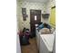 Laundry Room featuring vintage wallpaper, a laundry sink and stacked washer/dryer at 12231 Fort King Rd, Dade City, FL 33525