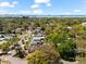 An aerial view of the property showcases the neighborhood, nearby waterways, and city skyline in the distance at 1232 Sedeeva S Cir, Clearwater, FL 33755