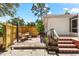 An outdoor dining area is shown on the brick patio of this home's backyard, accented with wooden fencing at 1232 Sedeeva S Cir, Clearwater, FL 33755