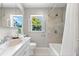 Well-lit bathroom featuring a shower/tub combo and marble countertop vanity at 1232 Sedeeva S Cir, Clearwater, FL 33755