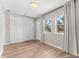 Bright bedroom with wood floors, white trim, and a large closet at 1232 Sedeeva S Cir, Clearwater, FL 33755