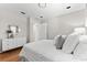 Clean, bright bedroom with white furniture and minimalist decorations at 1232 Sedeeva S Cir, Clearwater, FL 33755