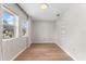 Well-lit bedroom with wood floors and built-in shelving for storage at 1232 Sedeeva S Cir, Clearwater, FL 33755