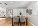 Open concept dining area with hardwood floors and accent wall art at 1232 Sedeeva S Cir, Clearwater, FL 33755