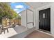 Charming front porch with a tiled floor and adjacent sitting area at 1232 Sedeeva S Cir, Clearwater, FL 33755