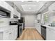 Modern kitchen featuring white cabinets, stainless steel appliances, and sleek countertops at 1232 Sedeeva S Cir, Clearwater, FL 33755