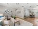 Open-concept living and dining area with wood floors and neutral decor at 1232 Sedeeva S Cir, Clearwater, FL 33755