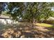 View of a shaded and private fenced backyard with mature trees and patio at 12597 Cumberland Dr, Largo, FL 33773