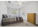 Cozy bedroom with plush carpeting, comfortable bed, and bright natural light at 12597 Cumberland Dr, Largo, FL 33773