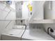 Bright laundry room with utility shelving, washer and dryer hookups, and water heater at 12597 Cumberland Dr, Largo, FL 33773