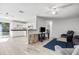 Open-concept living space featuring wood-look tile floors and an adjacent kitchen at 12597 Cumberland Dr, Largo, FL 33773