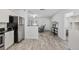 Bright living area featuring wood-look floors, white walls, and modern decor at 12597 Cumberland Dr, Largo, FL 33773