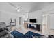 Spacious living room with modern furnishings, ceiling fan, and tile flooring at 12597 Cumberland Dr, Largo, FL 33773