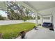 Backyard featuring a large grass area, planters and covered patio with outdoor furniture and privacy fence at 13460 Bergamont Cir, Tampa, FL 33618