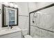 Modern bathroom with white marble walls, glass enclosed shower and matte black fixtures at 13460 Bergamont Cir, Tampa, FL 33618