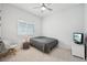 Cozy bedroom featuring a comfortable bed, wood-look floors and natural light at 13460 Bergamont Cir, Tampa, FL 33618