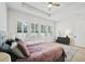 Bedroom featuring a cozy bed, soft rug, and bright windows with plantation shutters for natural light at 13460 Bergamont Cir, Tampa, FL 33618