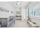 Bright bedroom featuring a gray crib, decor, and lots of natural light at 13460 Bergamont Cir, Tampa, FL 33618