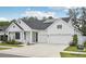 Beautiful home with solar panels, a driveway, two-car garage and well-maintained landscaping at 13460 Bergamont Cir, Tampa, FL 33618