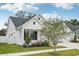 Stylish white home with a small tree in the front yard and walkway and manicured landscaping at 13460 Bergamont Cir, Tampa, FL 33618