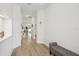 Bright and open hallway with neutral paint, light wood floors and a comfortable bench at 13460 Bergamont Cir, Tampa, FL 33618